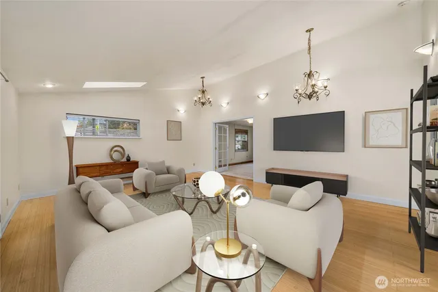 a living room with furniture and a chandelier