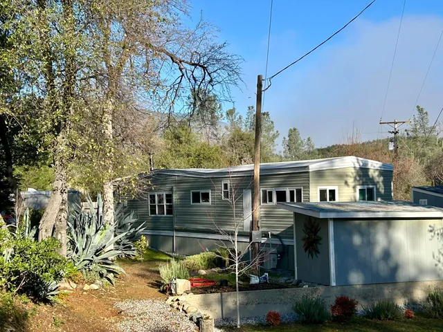 a backyard of a house with outdoor seating