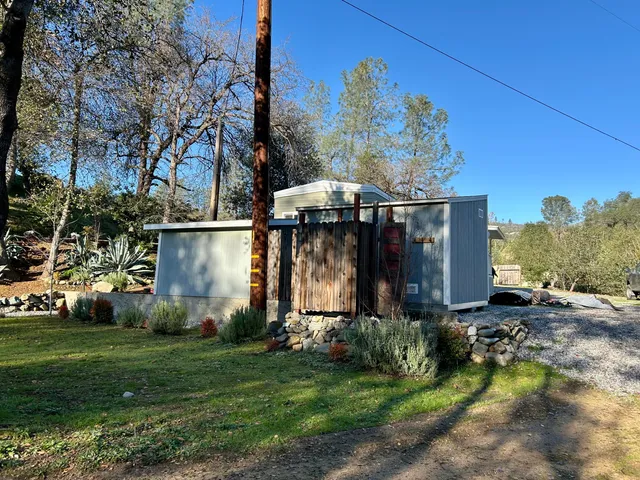 a view of a house with backyard and sitting area