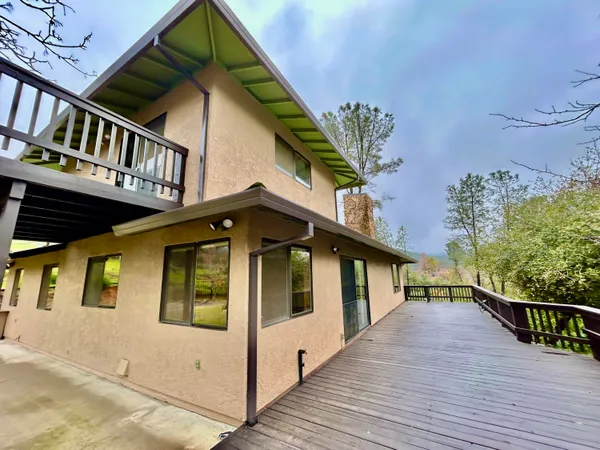 a view of a hallway with wooden floor and stairs