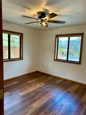 a kitchen with stainless steel appliances granite countertop a refrigerator a stove and a wooden floors