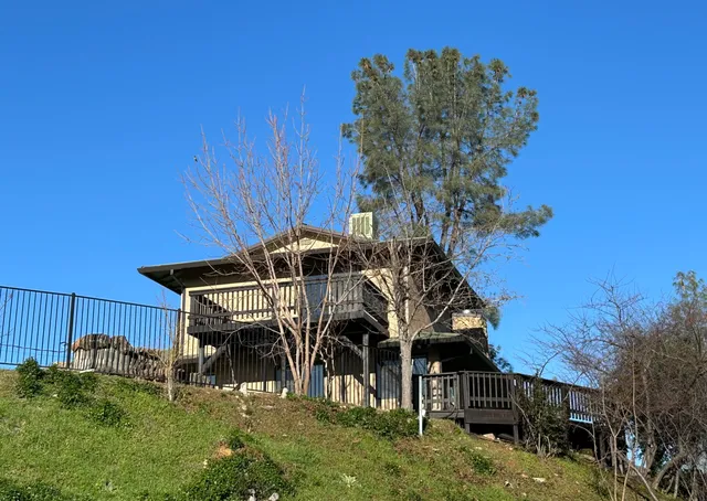 a view of a balcony next to a yard