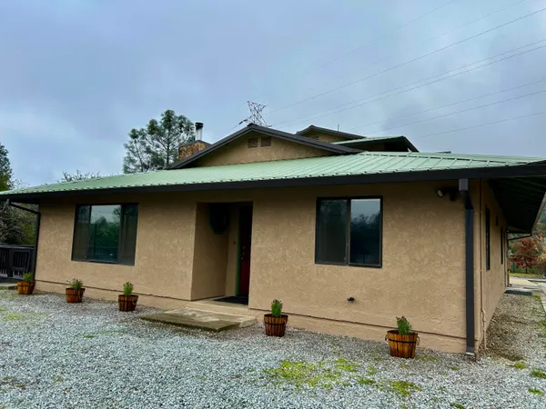 a view of a swimming pool with a patio and a garden