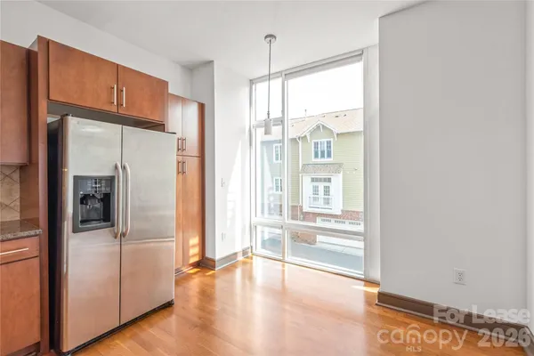 a view of a kitchen with a refrigerator and a sink