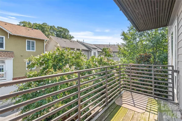 a view of a balcony with wooden floor and fence