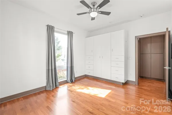 an empty room with wooden floor and closet