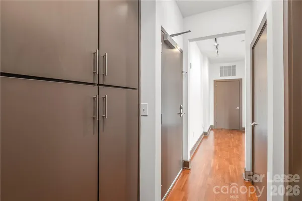 a view of hallway with stairs and a wooden floor
