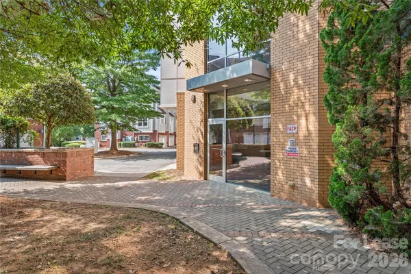 a view of a house with a yard and tree s