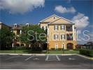 3707 Conroy Road, Unit 1725 Orlando, FL 32839 - Photo 1 of 1 a view of a brick building next to a yard