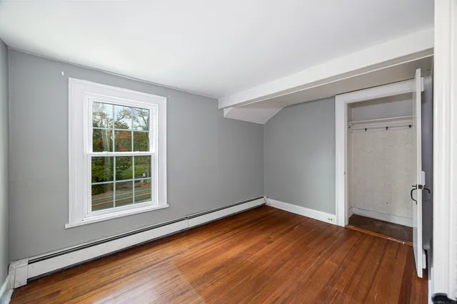 a view of a room with wooden floor and window
