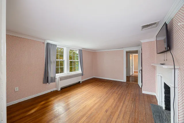 a view of livingroom with hardwood floor and fireplace