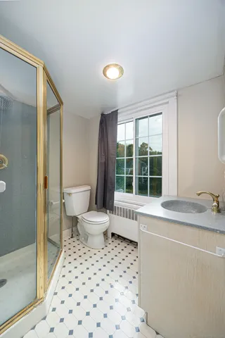 a bathroom with a sink toilet and shower