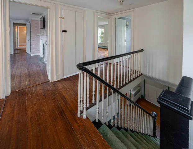 a view of staircase with wooden floor and a window