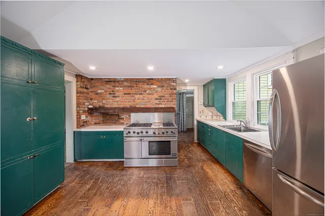 a kitchen with stainless steel appliances a refrigerator sink and stove