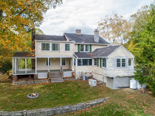 a front view of a house with a yard table and chairs