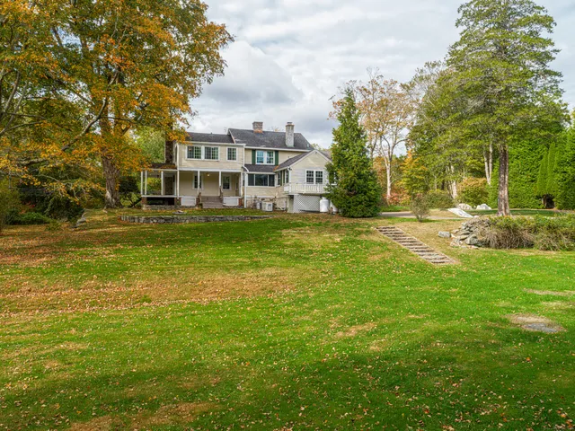 a view of a large building with a big yard and large trees