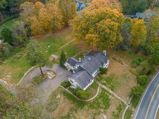 an aerial view of a house with a yard