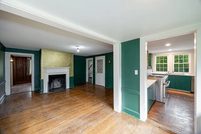 an empty room with fireplace and windows