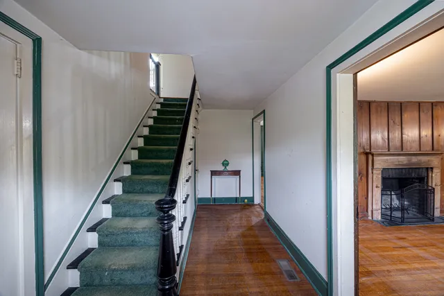 a view of entryway and hall with wooden floor