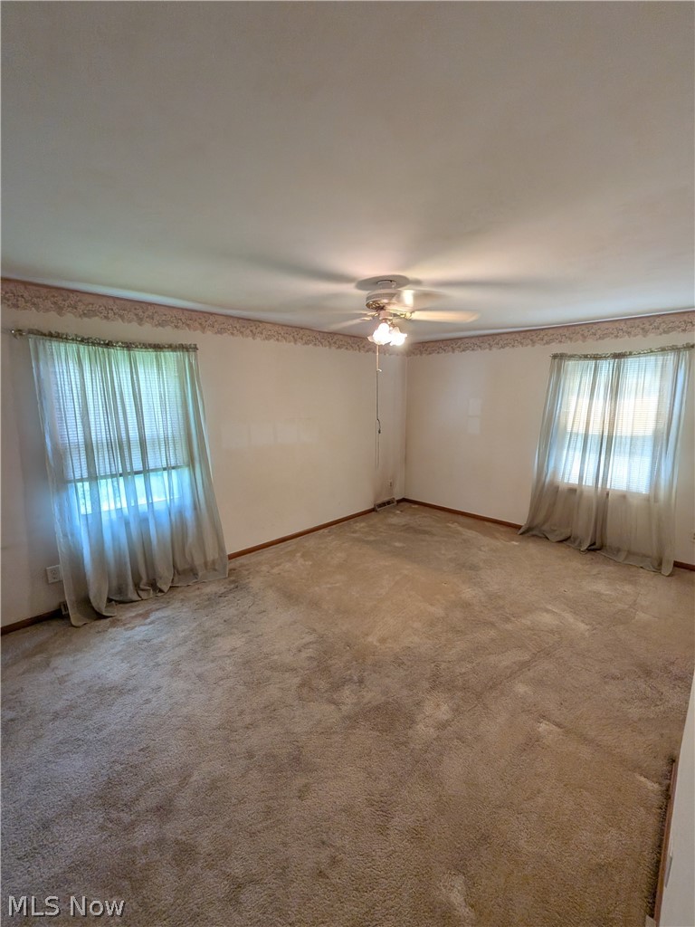 1161 Gulf Road Elyria, OH 44035 - Photo 19 of 34 Carpeted room with a ceiling fan light fixture and two windows