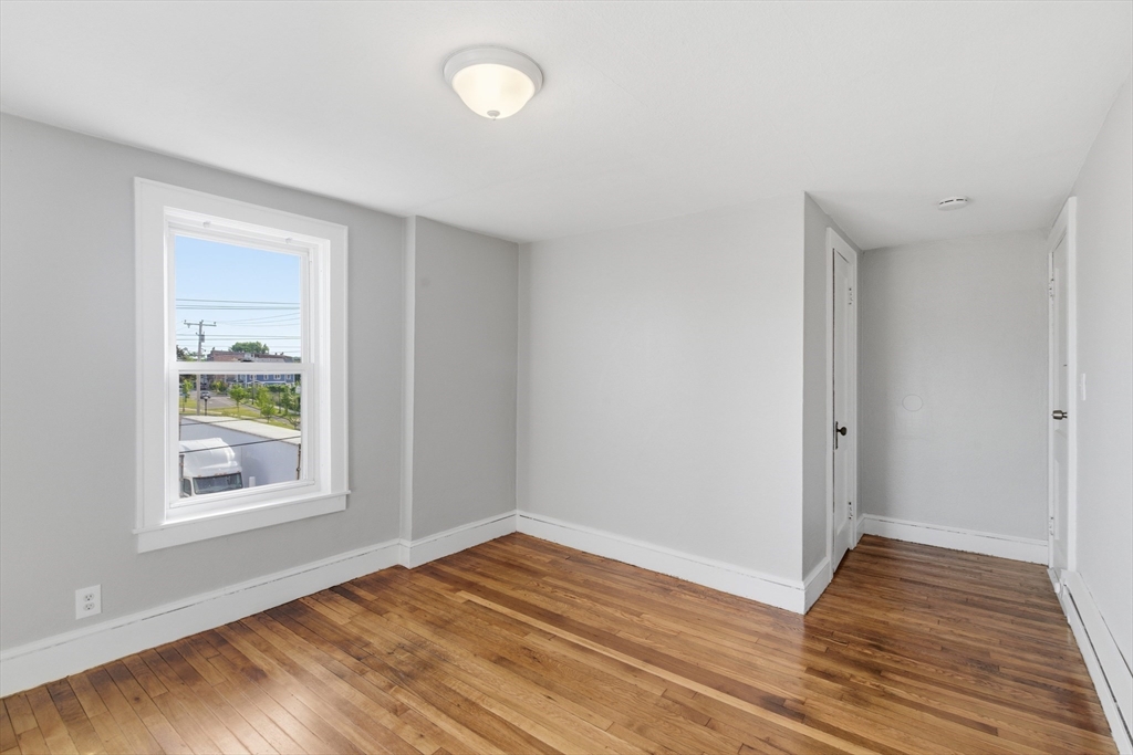 293 Clemente Street, Unit 3R Holyoke, MA 01040 - Photo 13 of 14 a view of empty room with wooden floor and fan