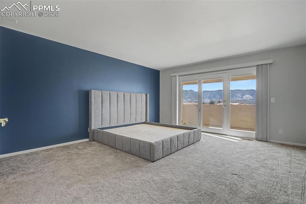 20 Luxury Lane Colorado Springs, CO 80921 - Photo 18 of 36 a room with a bed and a large window