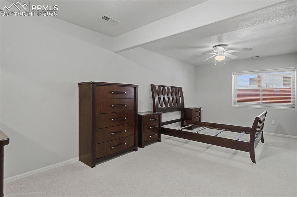 20 Luxury Lane Colorado Springs, CO 80921 - Photo 23 of 36 a bedroom with a bed and a ceiling fan