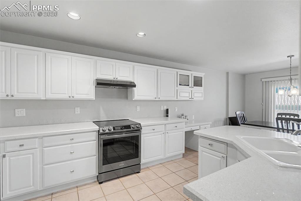 20 Luxury Lane Colorado Springs, CO 80921 - Photo 6 of 36 a kitchen with white cabinets stainless steel appliances and sink
