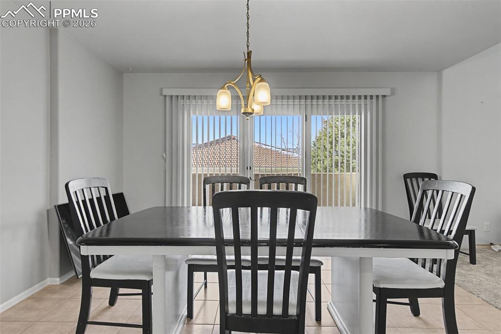 20 Luxury Lane Colorado Springs, CO 80921 - Photo 10 of 36 a view of a dining room with furniture window and wooden floor