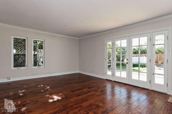 187 Kanan Road Oak Park, CA 91377 - Photo 11 of 20 a view of an empty room with wooden floor and a window