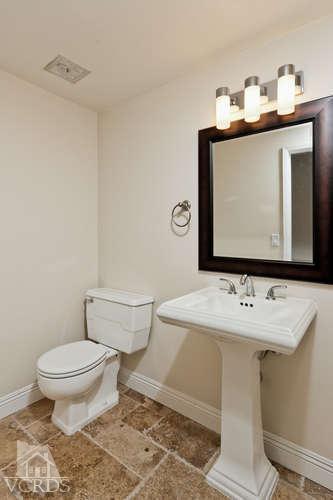 187 Kanan Road Oak Park, CA 91377 - Photo 18 of 20 a bathroom with a toilet sink and mirror