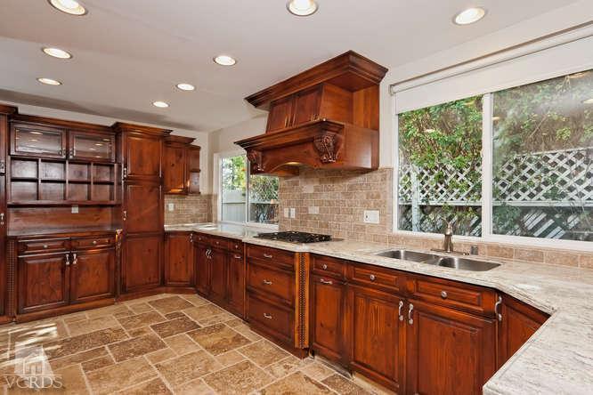 187 Kanan Road Oak Park, CA 91377 - Photo 9 of 20 a kitchen with stainless steel appliances granite countertop a sink stove and cabinets