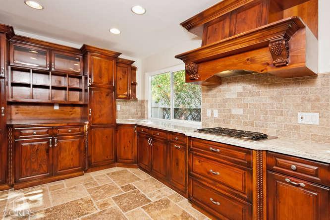 187 Kanan Road Oak Park, CA 91377 - Photo 10 of 20 a kitchen with stainless steel appliances granite countertop a sink and cabinets