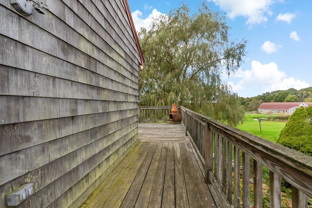 3211 Main Road Tiverton, RI 02878 - Photo 12 of 34 a view of a balcony with wooden floor and fence