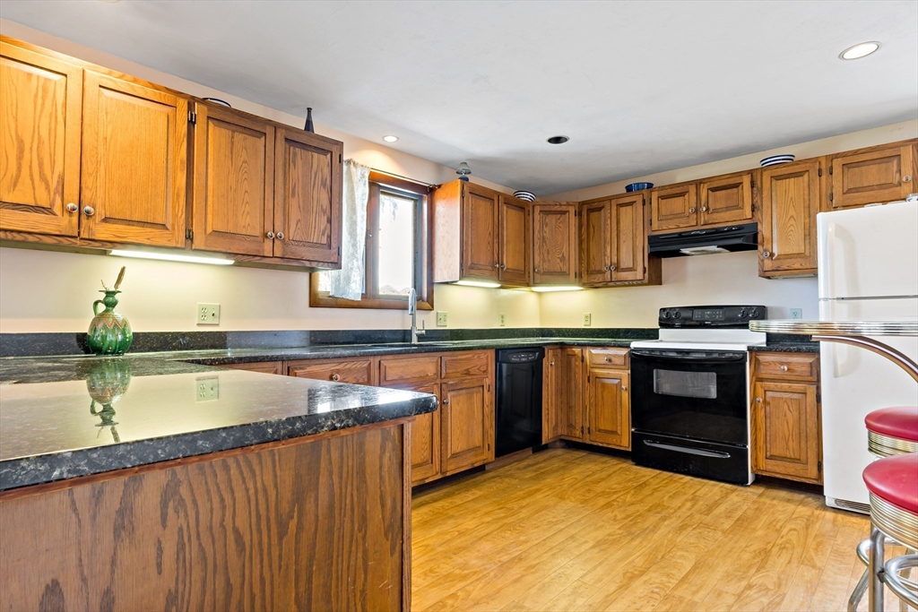 3211 Main Road Tiverton, RI 02878 - Photo 14 of 34 a kitchen with stainless steel appliances granite countertop a stove a sink and a microwave
