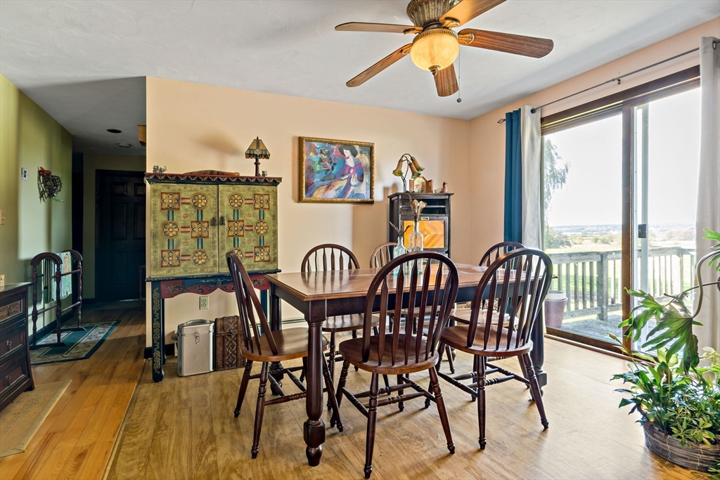 3211 Main Road Tiverton, RI 02878 - Photo 18 of 34 a view of a dining room and livingroom with furniture window and wooden floor