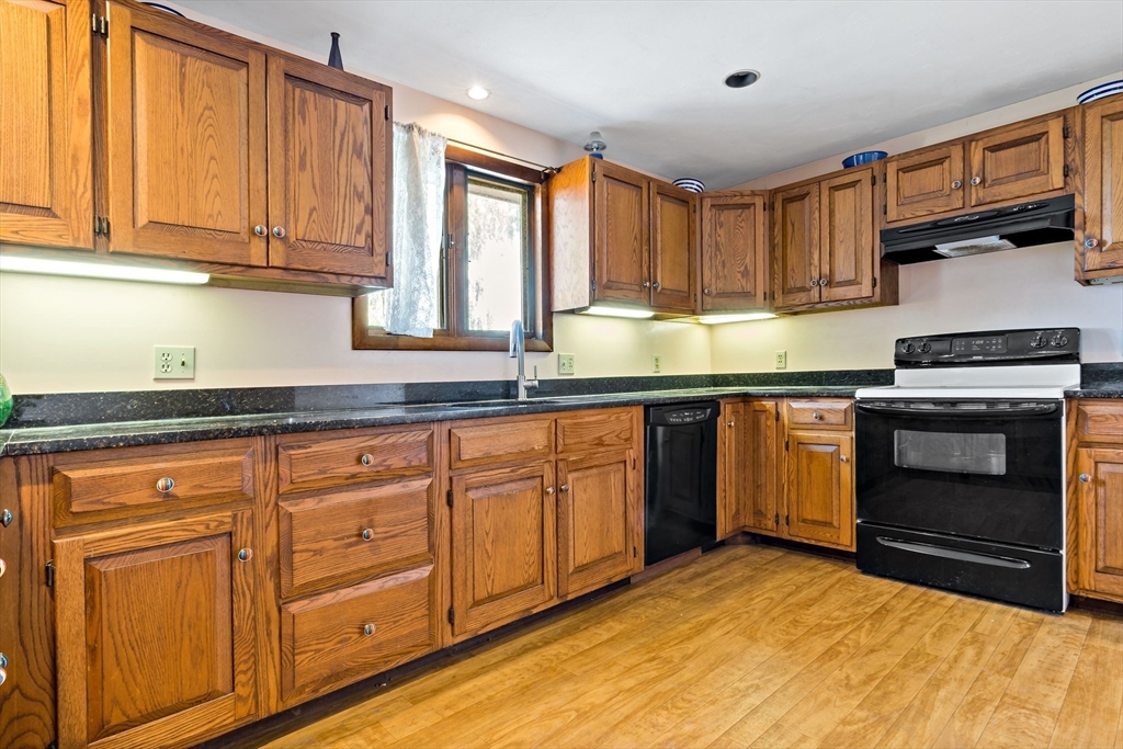 3211 Main Road Tiverton, RI 02878 - Photo 19 of 34 a kitchen with granite countertop cabinets stainless steel appliances and a sink
