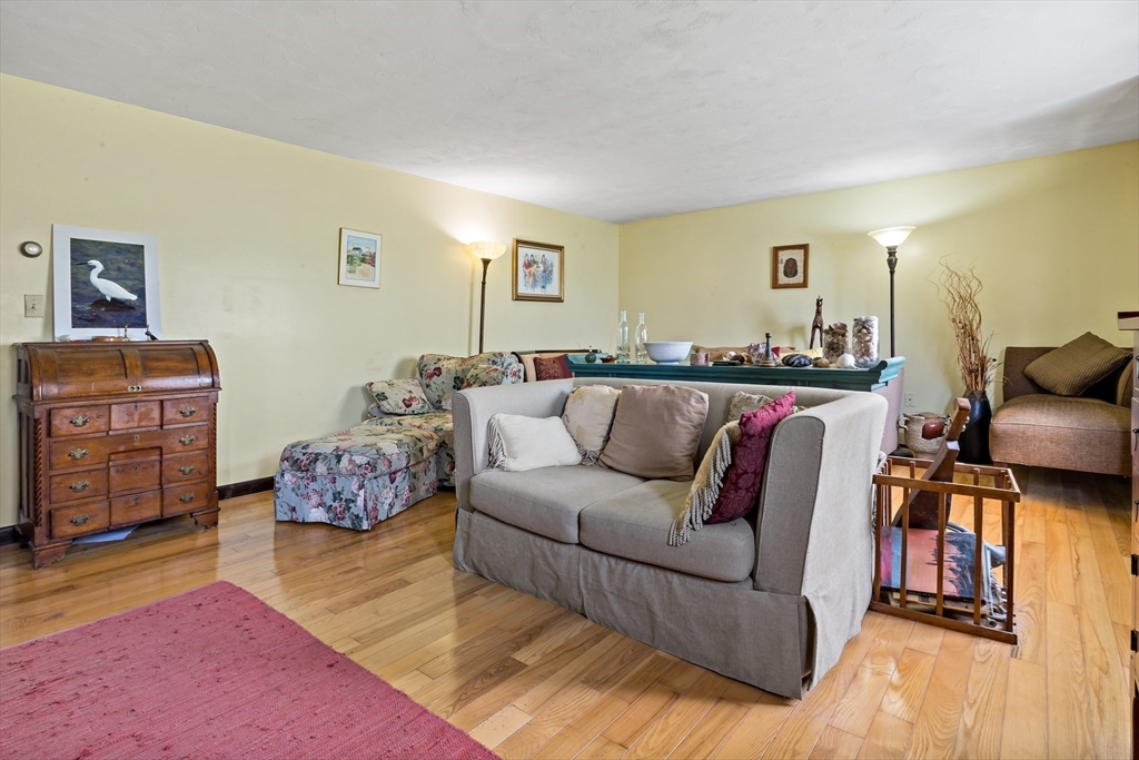 3211 Main Road Tiverton, RI 02878 - Photo 24 of 34 a living room with furniture and painting on the wall