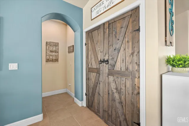 a view of a room that has a large window and wooden floor