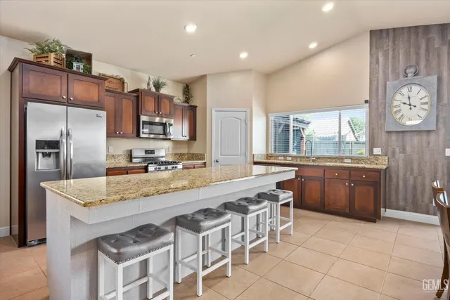 a large kitchen with a table and chairs