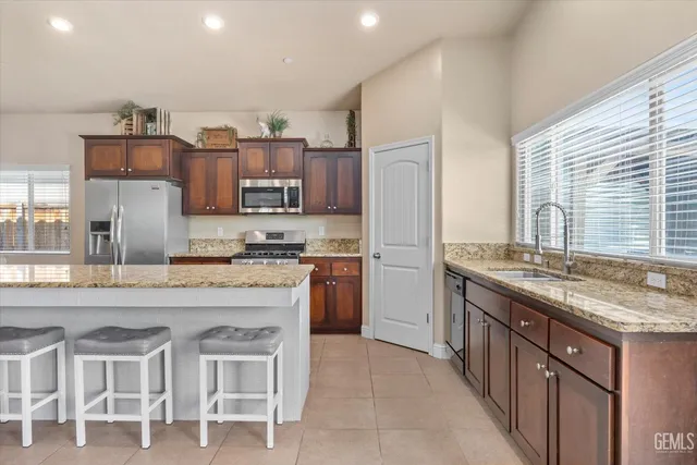 a kitchen with cabinets and refrigerator
