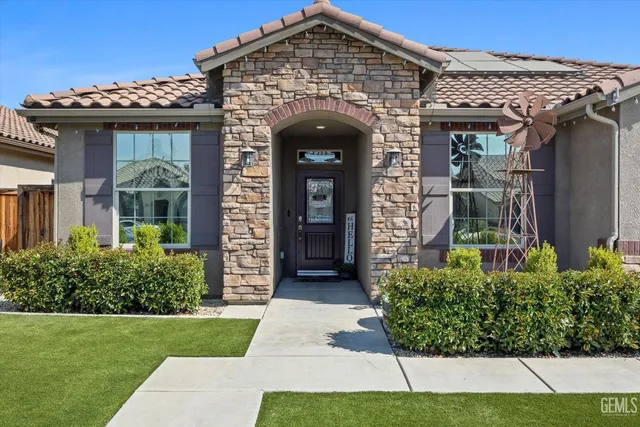 a front view of a house with garden