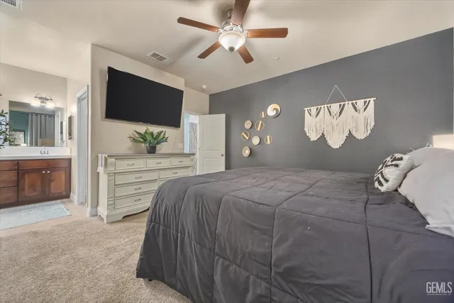 a bedroom with a large bed and a flat screen tv