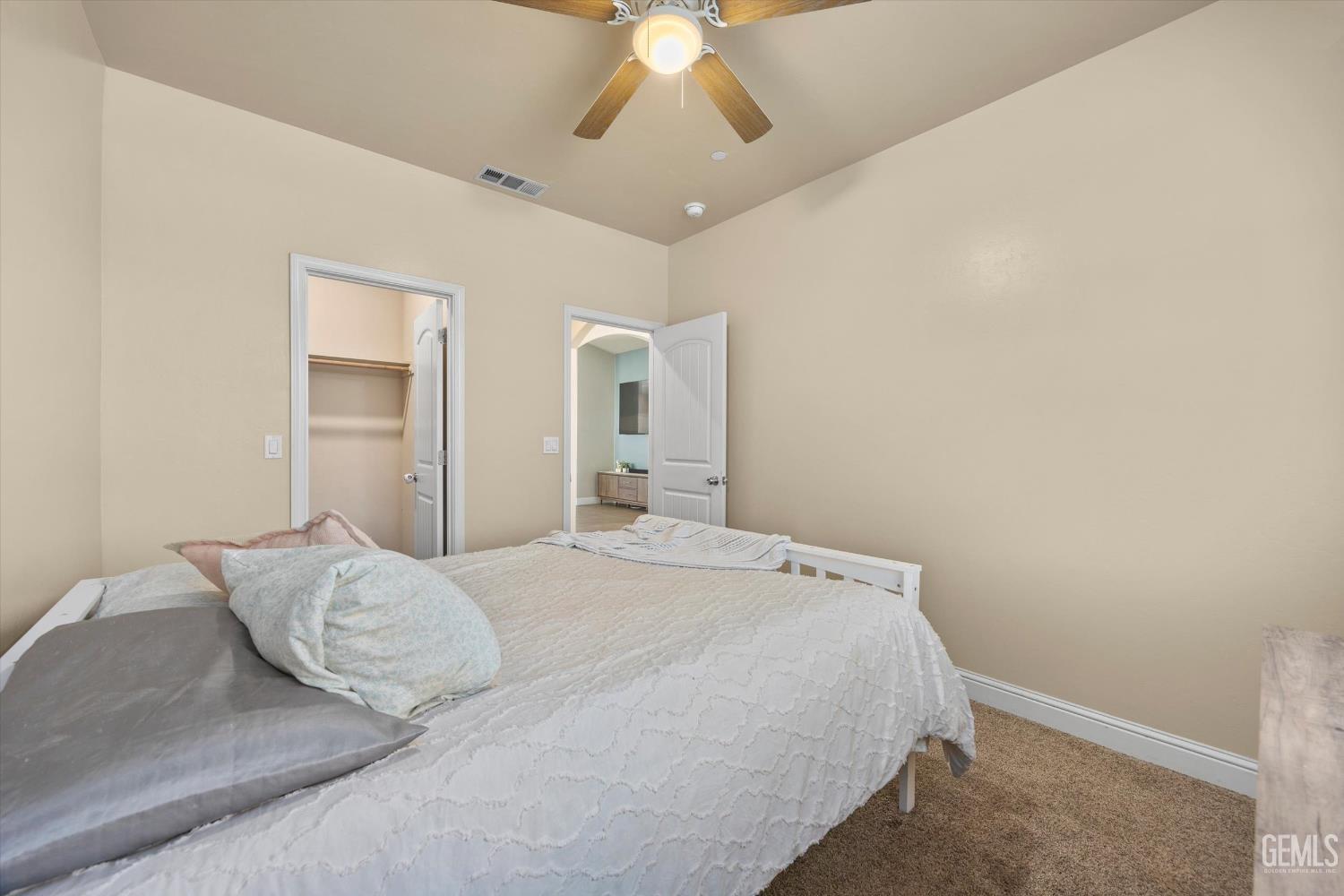 Undisclosed Address Shafter, CA 93263 - Photo 25 of 40 a bedroom with a large bed and a chandelier