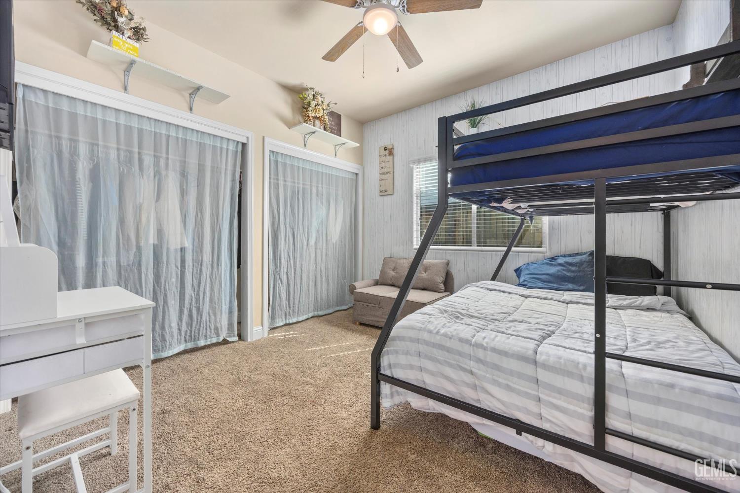 Undisclosed Address Shafter, CA 93263 - Photo 26 of 40 a bedroom with a bed and a chandelier