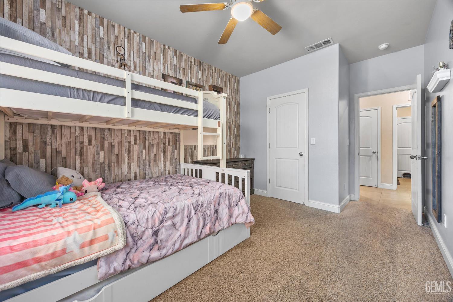 Undisclosed Address Shafter, CA 93263 - Photo 30 of 40 a bedroom with a bed and a chandelier