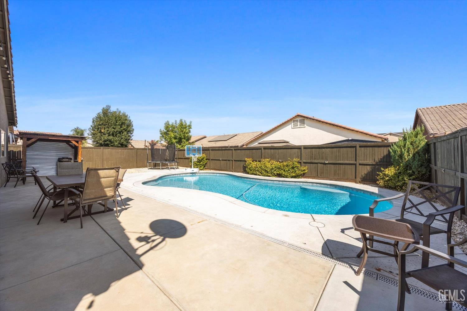 Undisclosed Address Shafter, CA 93263 - Photo 31 of 40 a view of a swimming pool with lounge chairs