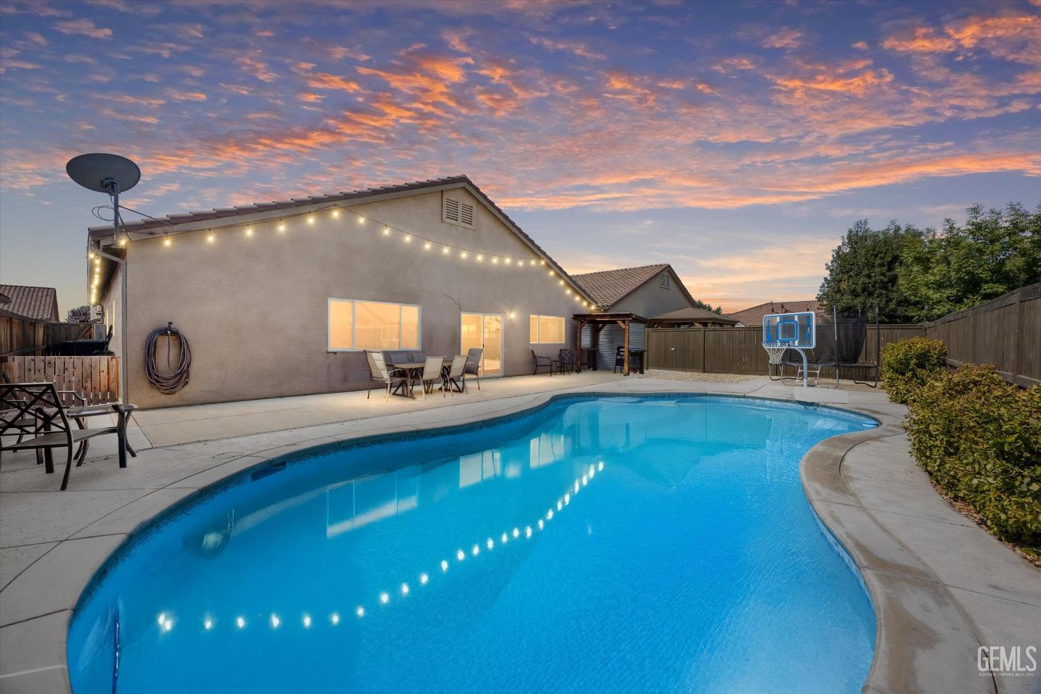 Undisclosed Address Shafter, CA 93263 - Photo 36 of 40 a view of a swimming pool with seating space