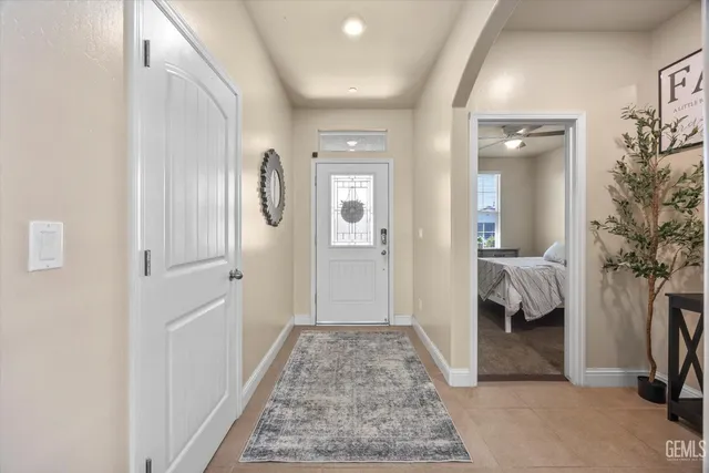 a view of a hallway with bedroom and wooden floor