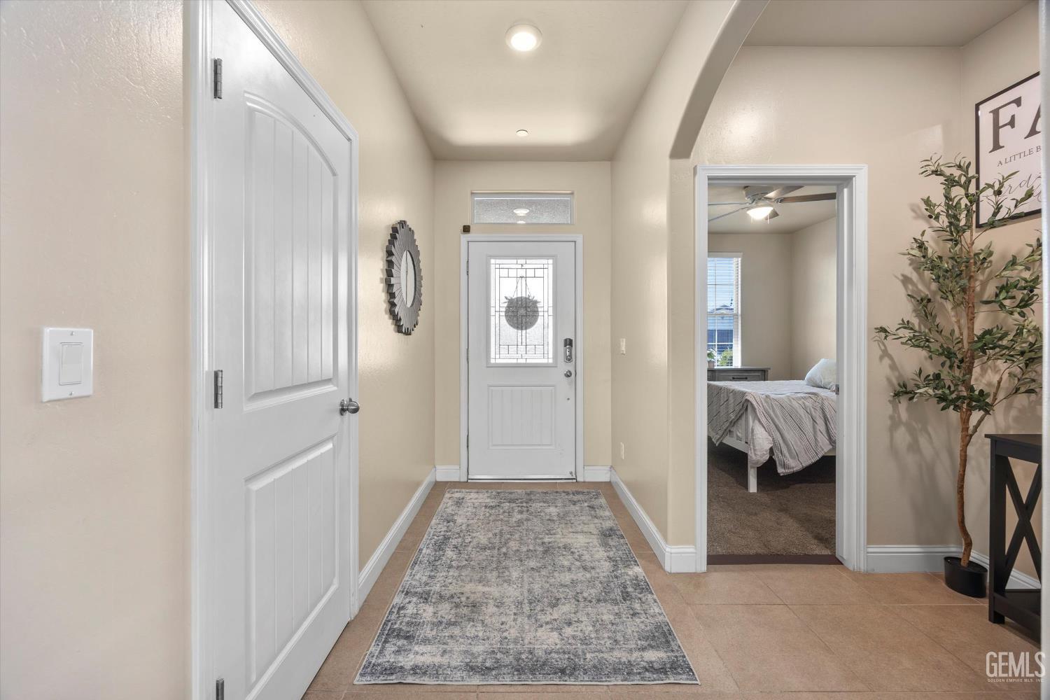 Undisclosed Address Shafter, CA 93263 - Photo 5 of 40 a view of a hallway with bedroom and wooden floor